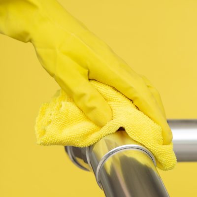 hand-with-surgical-glove-disinfecting-hand-rail-with-cloth Construction Rags