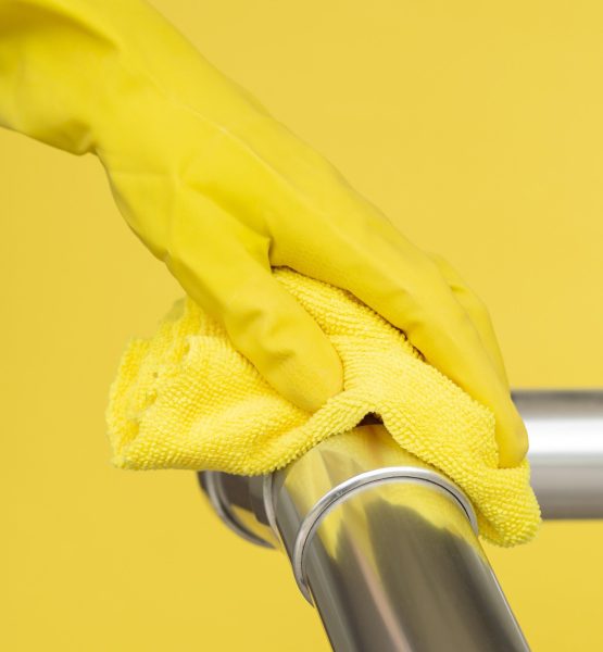 hand-with-surgical-glove-disinfecting-hand-rail-with-cloth Construction Rags